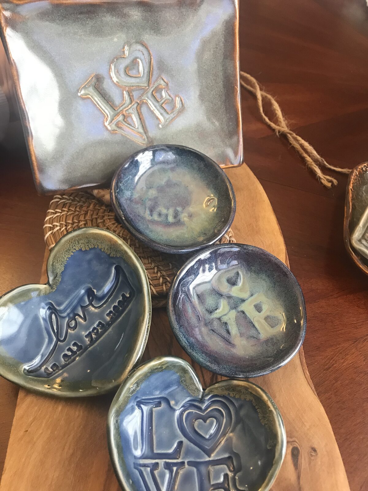 Small heart-shaped and round trinket dishes with LOVE stamps in blue and purple glazes